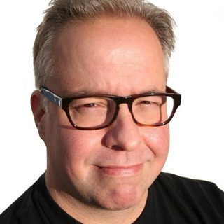 Christopher Abraham, SEO consultant, smiling in dark-rimmed glasses